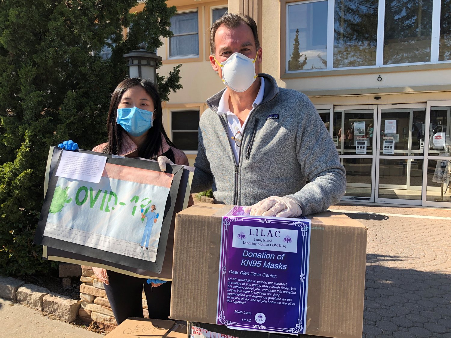 Syosset High School student Sabrina Guo, left, and Congressman Tom Suozzi take part in a donation of 1,000 PPE.